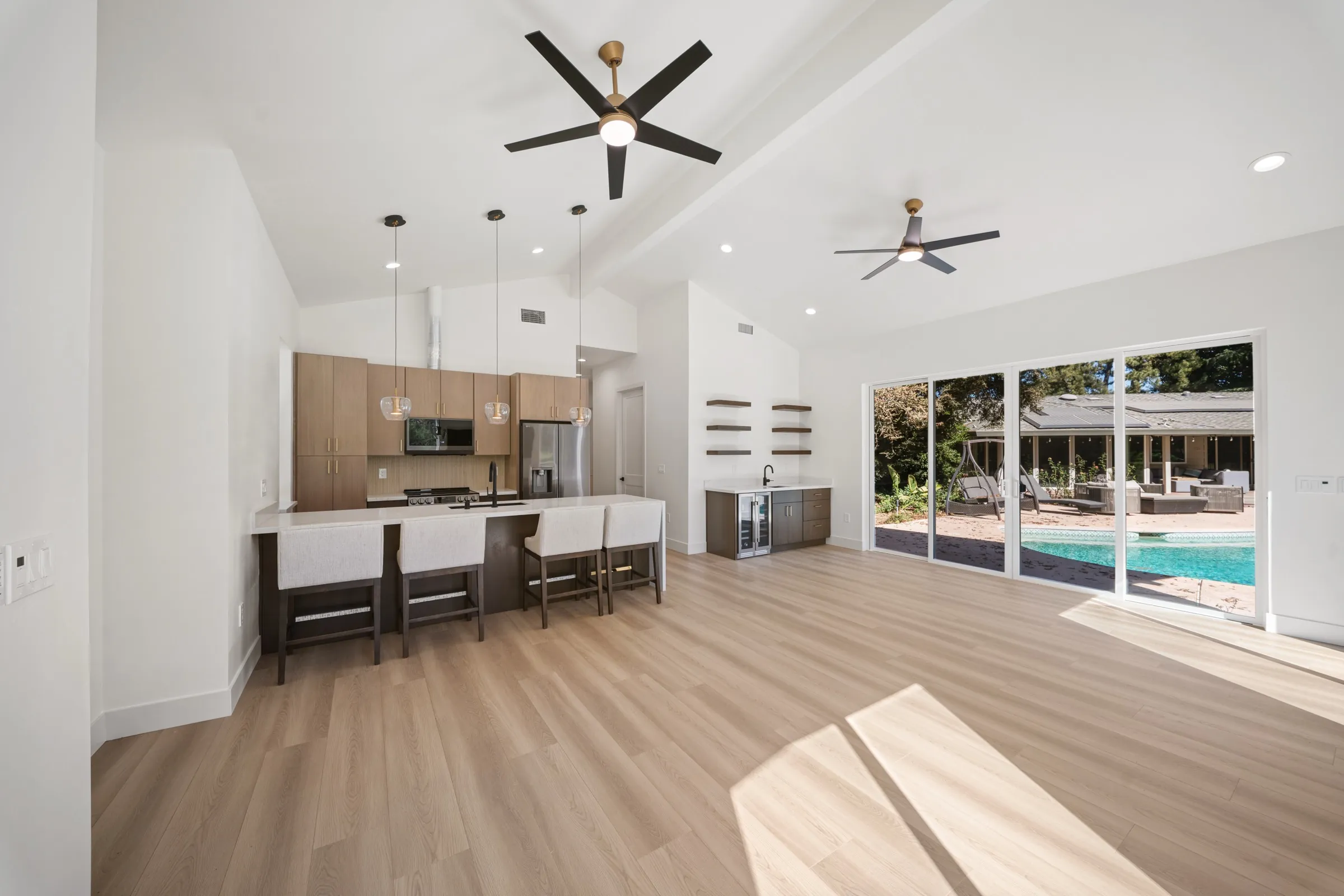 An ADU great room and kitchen with sliding doors to a pool